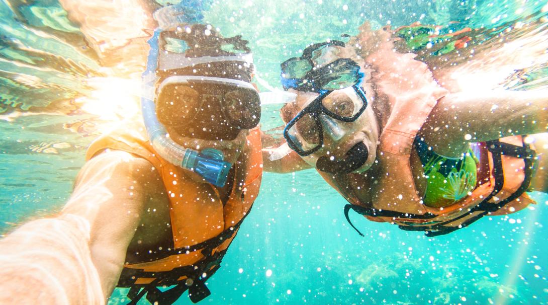 Discovery Tour travellers explore the underwater beauty in Fiji. A couple go snorkelling during their Authentic Adventure in Fiji.